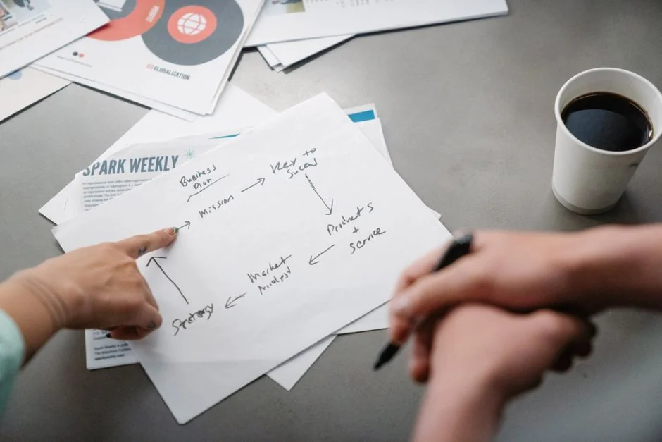 A top-down view of charts and a smartphone in an office, highlighting data analytics.